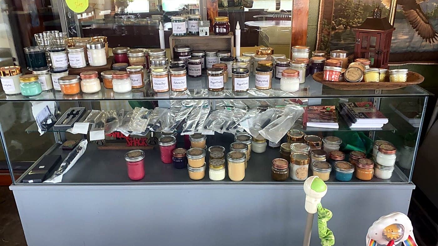 A display case of handmade candles and gifts from The Candle Shack at Sunrise Catfish Farm